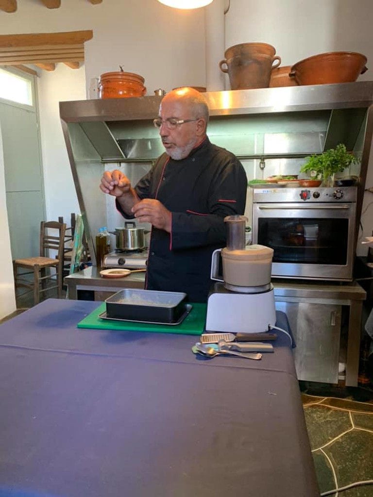 man cooking at 'Narlis Farm' kitchen with electric stove and toaster oven in the background